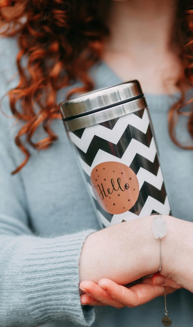 Selective Focus Photography of Woman Holding Tumbler